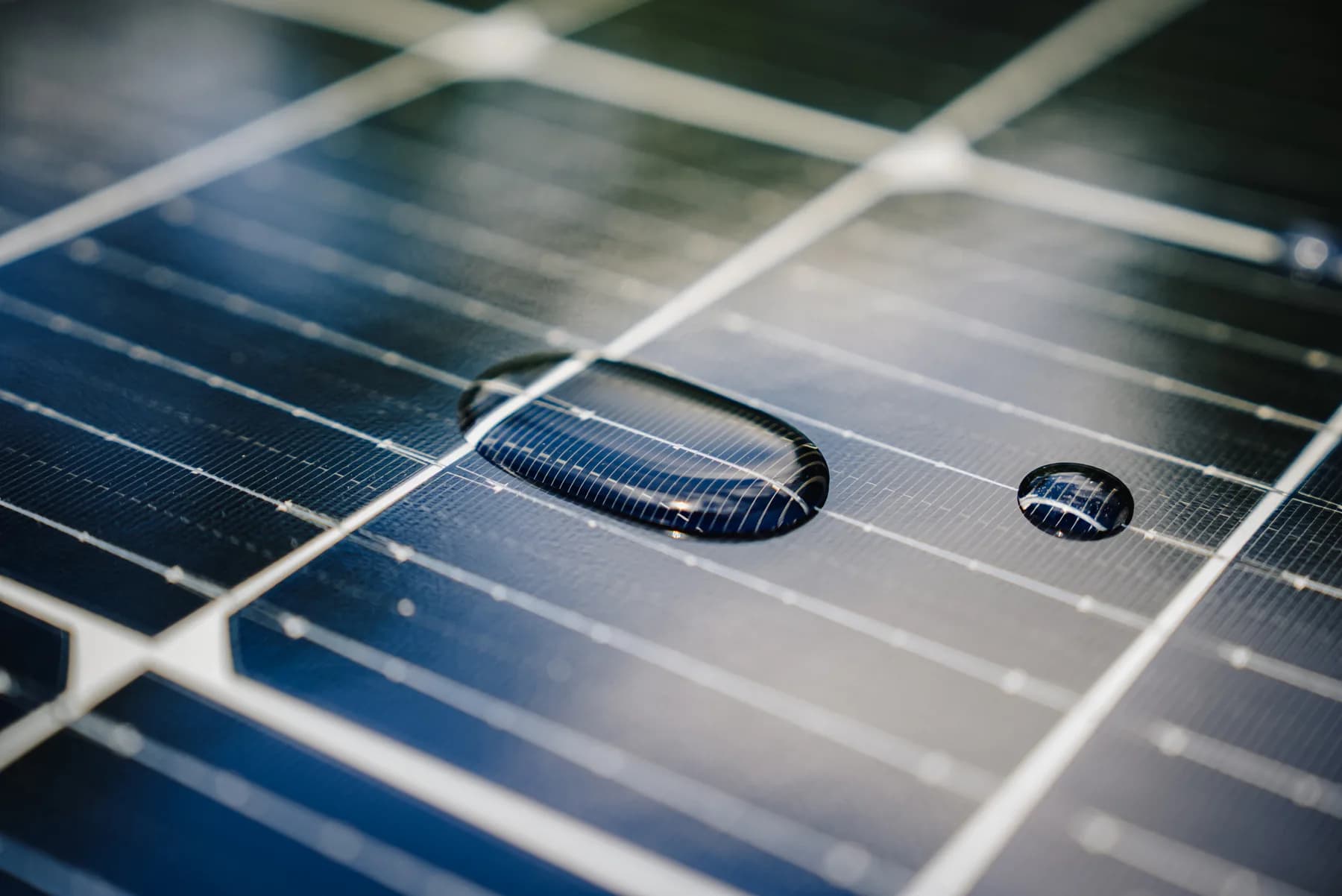 Close-up of water droplets beading on photovoltaic panel glass